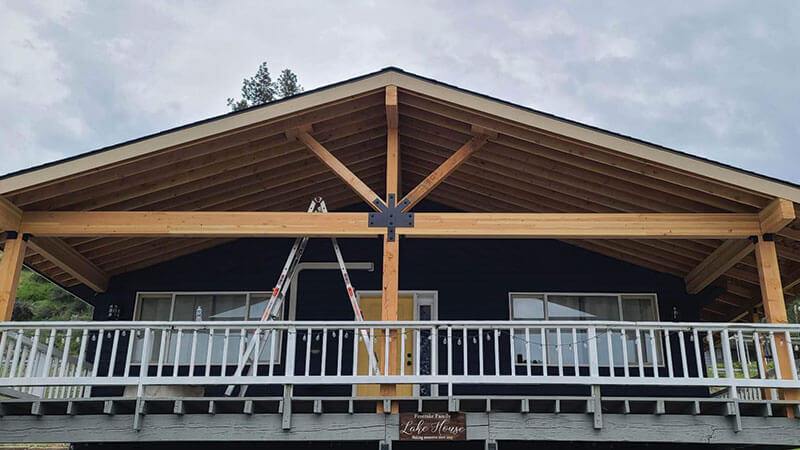 Heavy-timber gable truss detail on a custom home porch built by Gitter Done Construction