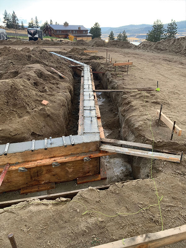 Poured concrete foundation footings with rebar at a Davenport, WA jobsite