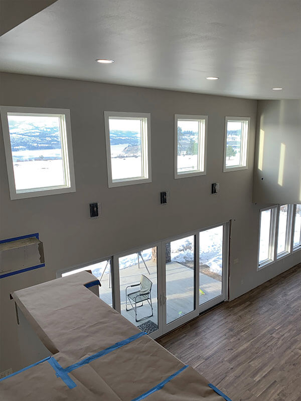 Finished great room interior with large windows, valley views and hardwood floors
